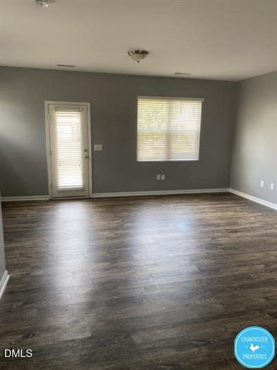 8960 Commons Townes Drive Raleigh, NC 27616 - Photo 6 of 13 an empty room with wooden floor and windows