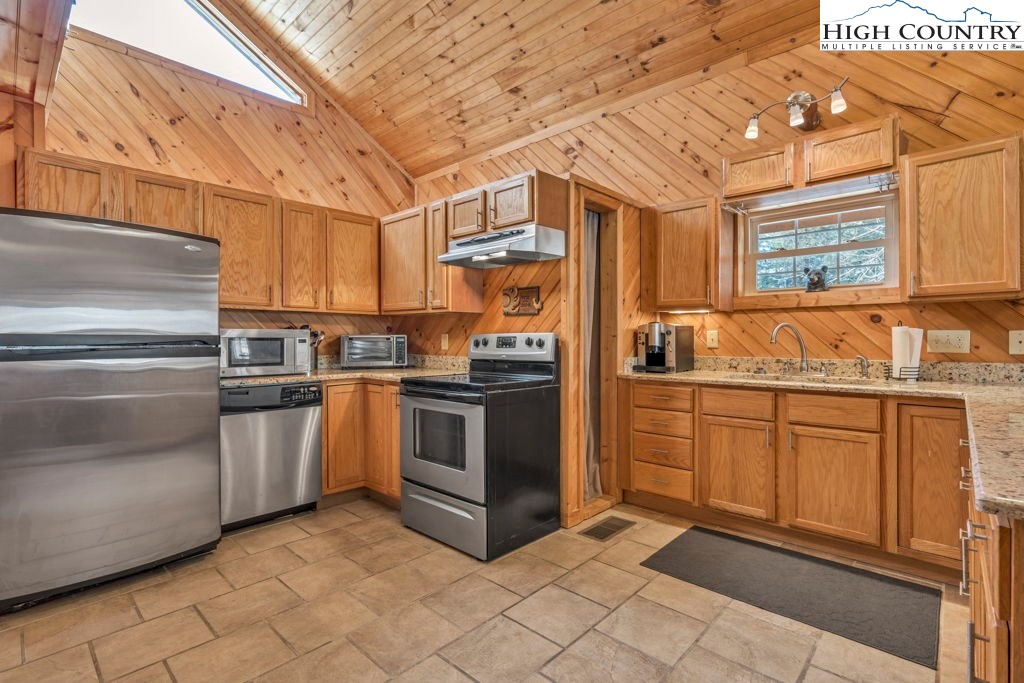 173 Spring Brook Road Newland, NC 28657 - Photo 7 of 39 a kitchen with stainless steel appliances granite countertop a stove and a sink