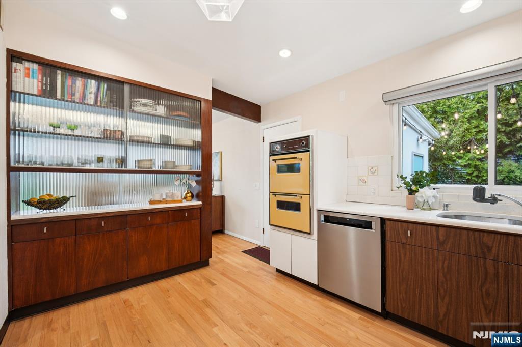 208 Prospect Avenue Oradell, NJ 07649 - Photo 16 of 50 a kitchen with stainless steel appliances granite countertop a sink and wooden cabinets