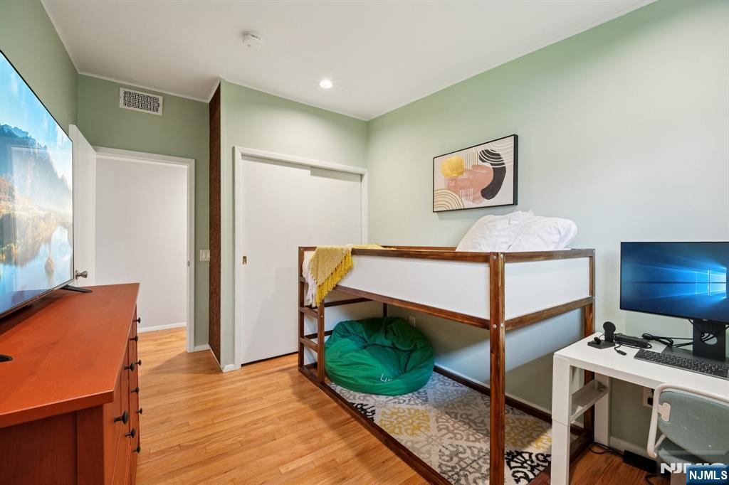 208 Prospect Avenue Oradell, NJ 07649 - Photo 26 of 50 a bedroom with a bed and a dresser in it