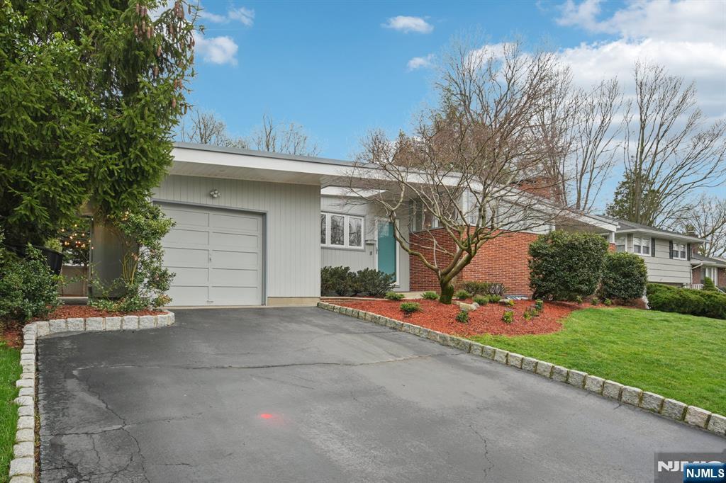208 Prospect Avenue Oradell, NJ 07649 - Photo 3 of 50 a front view of a house with a yard and garage