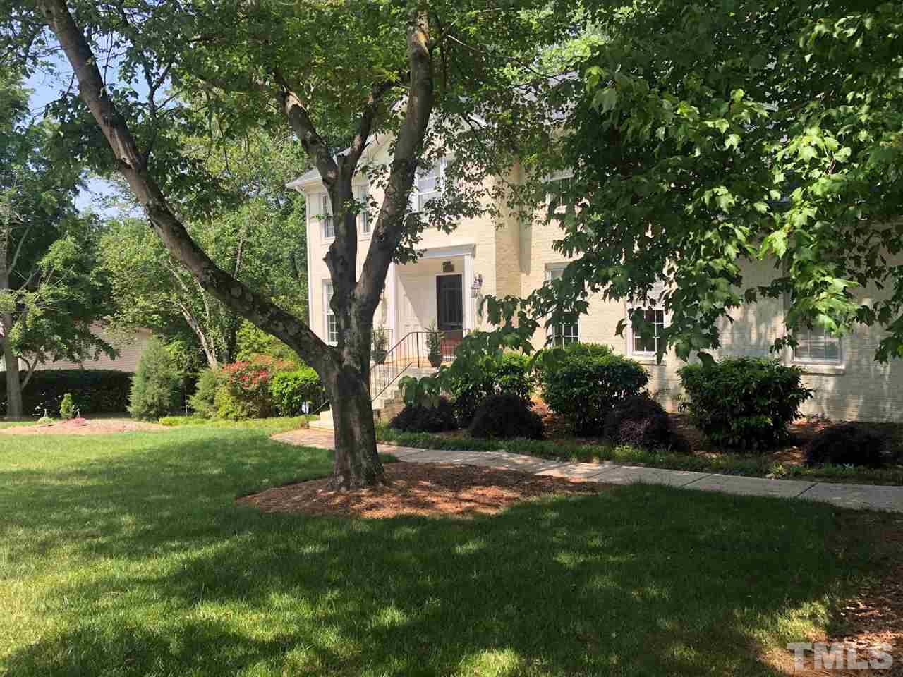 7919 Harps Mill Road Raleigh, NC 27615 - Photo 2 of 29 a view of a house with a tree in a yard