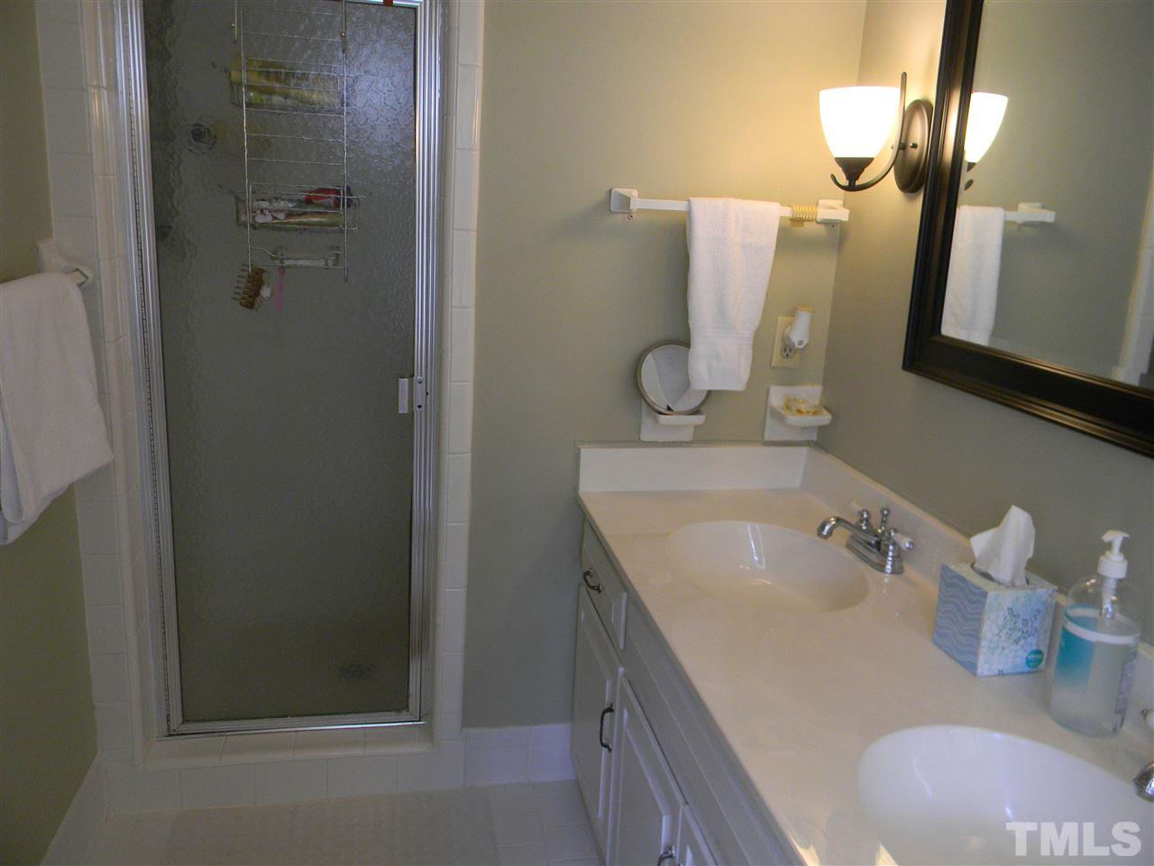 7919 Harps Mill Road Raleigh, NC 27615 - Photo 12 of 29 a bathroom with a sink vanity and mirror