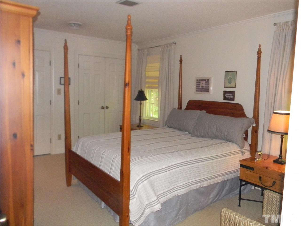 7919 Harps Mill Road Raleigh, NC 27615 - Photo 13 of 29 a bedroom with a bed and a window