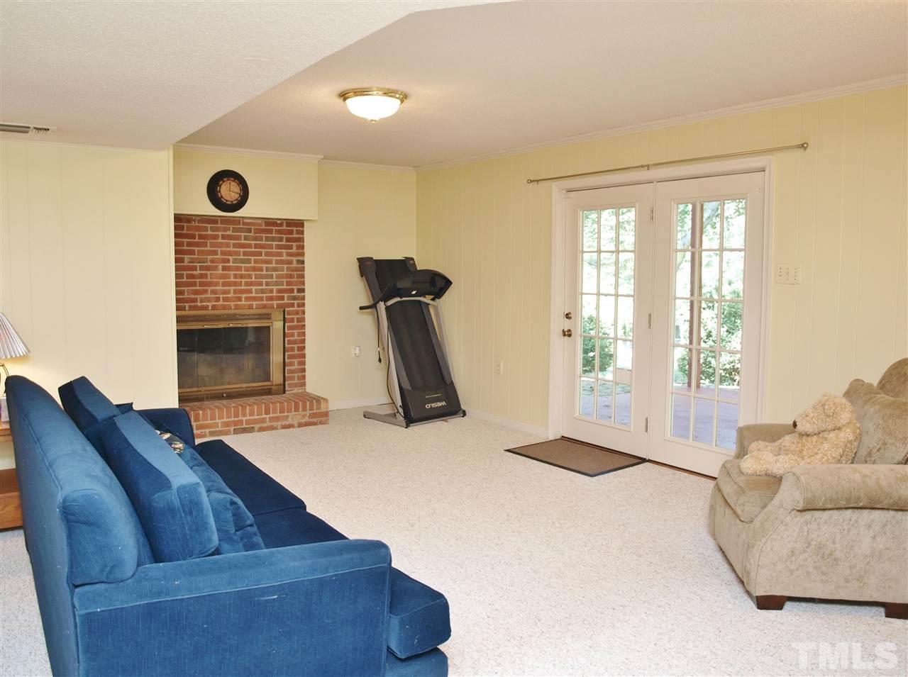 7919 Harps Mill Road Raleigh, NC 27615 - Photo 16 of 29 a living room with furniture and a fireplace