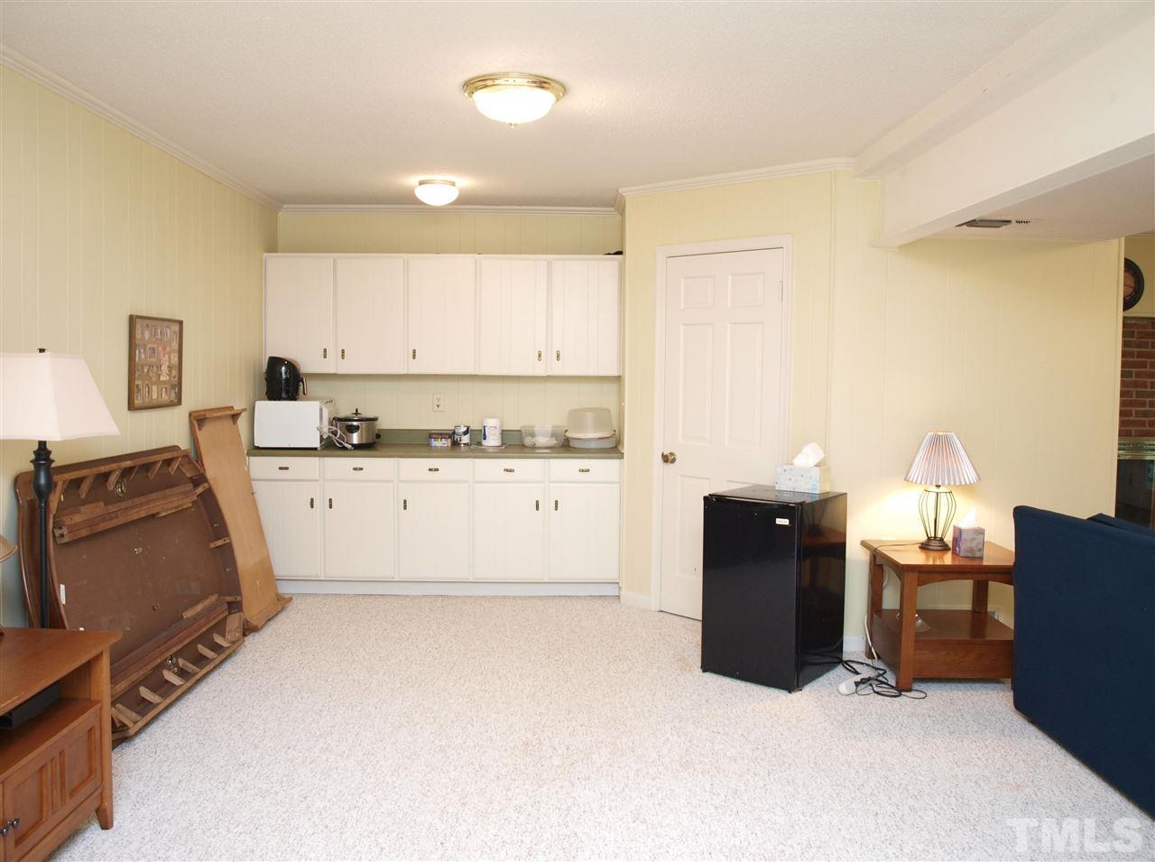 7919 Harps Mill Road Raleigh, NC 27615 - Photo 17 of 29 a view of kitchen with cabinets and wooden floor