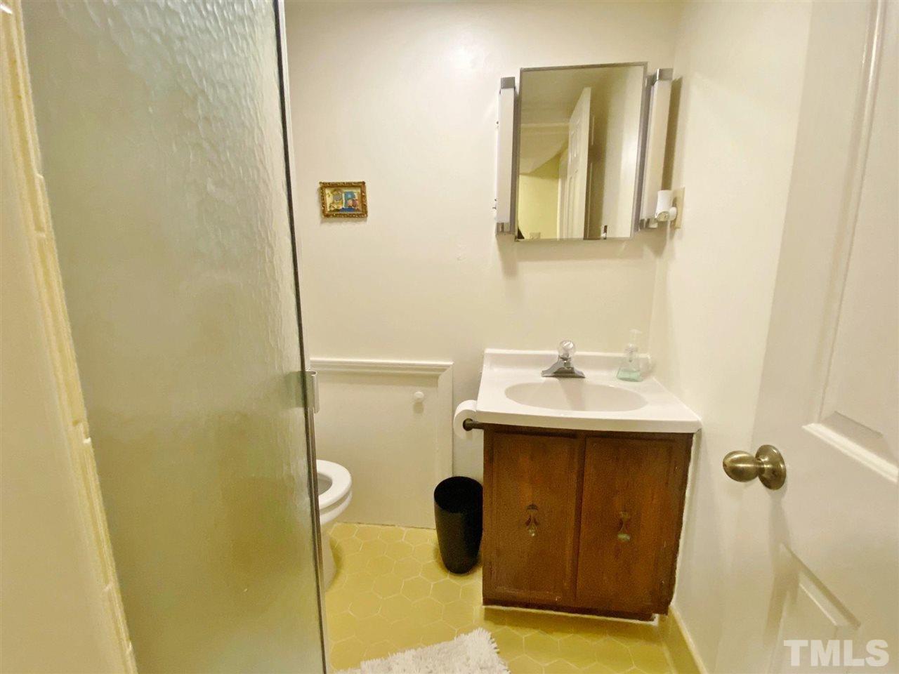 7919 Harps Mill Road Raleigh, NC 27615 - Photo 19 of 29 a bathroom with a sink and mirror