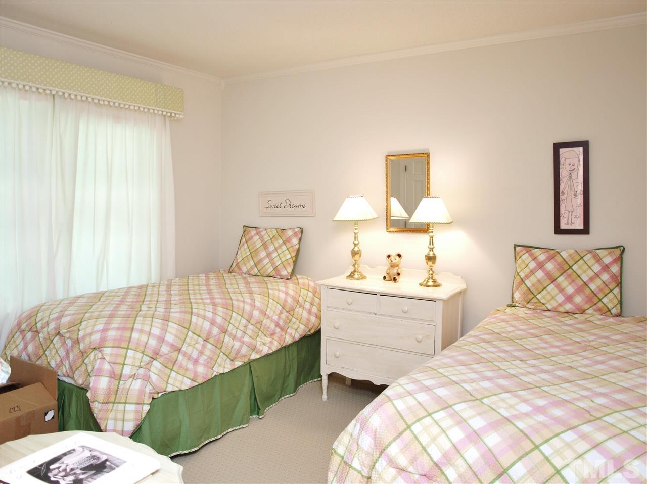 7919 Harps Mill Road Raleigh, NC 27615 - Photo 20 of 29 a bedroom with a bed and window