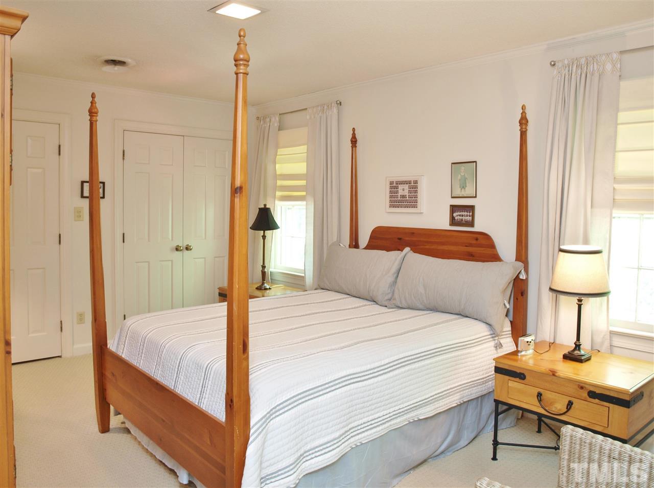 7919 Harps Mill Road Raleigh, NC 27615 - Photo 21 of 29 a bedroom with a bed and a table