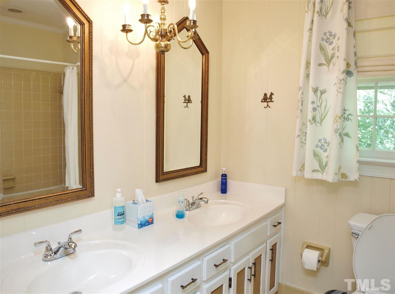 7919 Harps Mill Road Raleigh, NC 27615 - Photo 22 of 29 a bathroom with a sink and a mirror with toilet