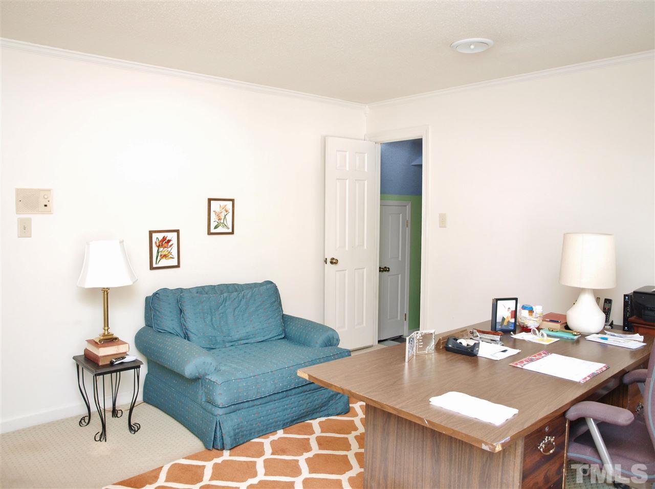 7919 Harps Mill Road Raleigh, NC 27615 - Photo 24 of 29 a living room with furniture and a table