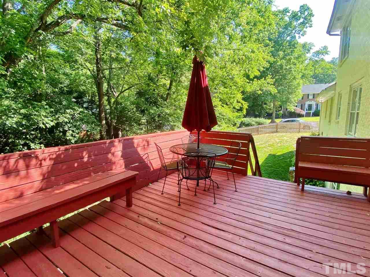 7919 Harps Mill Road Raleigh, NC 27615 - Photo 26 of 29 a view of a deck with wooden floor and outdoor seating