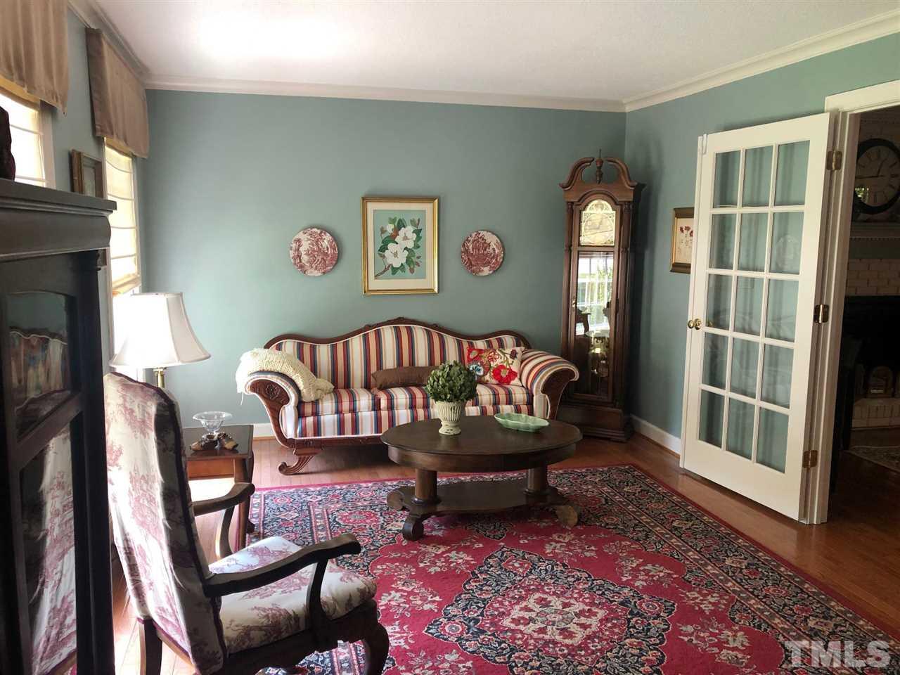7919 Harps Mill Road Raleigh, NC 27615 - Photo 5 of 29 a living room with furniture and a rug