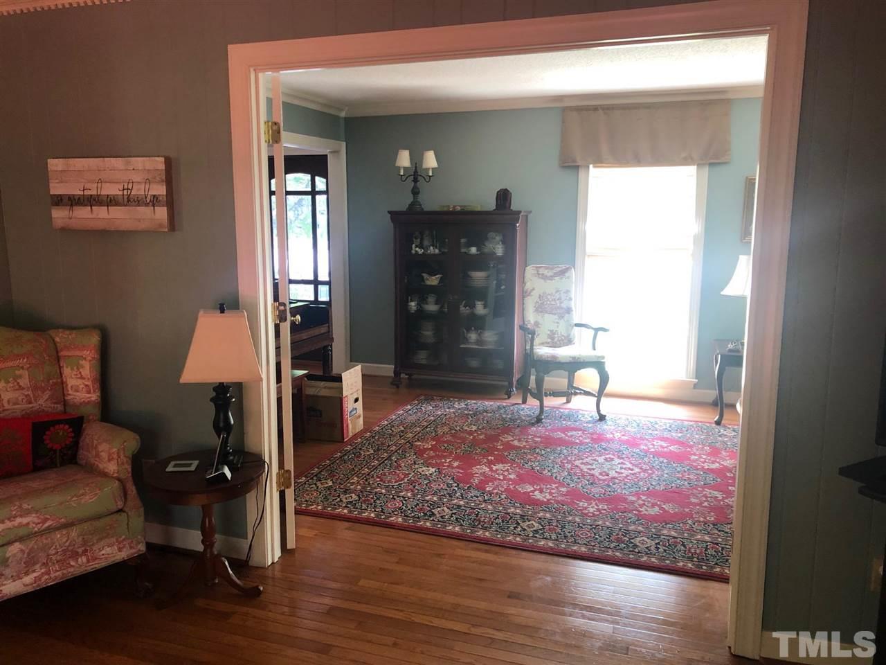 7919 Harps Mill Road Raleigh, NC 27615 - Photo 6 of 29 a living room with furniture and a wooden floor