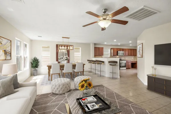 a living room with furniture and kitchen view