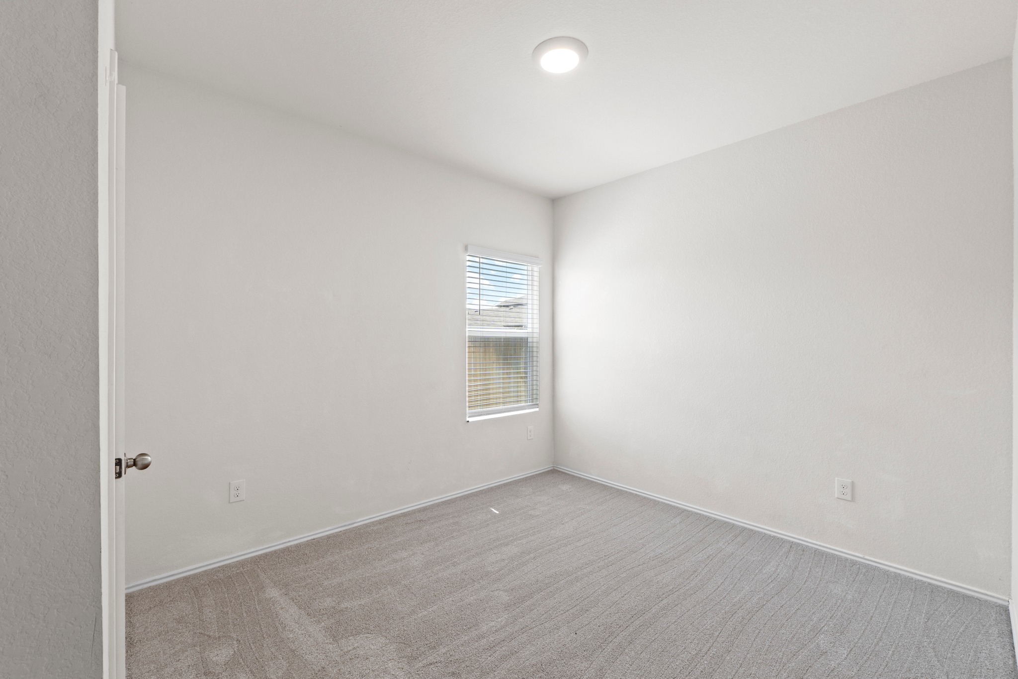 14917 Bajada Rd Manor Manor, TX 78653 - Photo 14 of 31 Carpeted room with a single window featuring horizontal blinds
