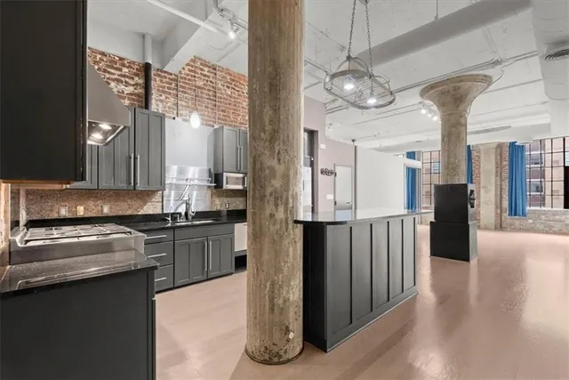 a kitchen with stainless steel appliances granite countertop a stove and a refrigerator