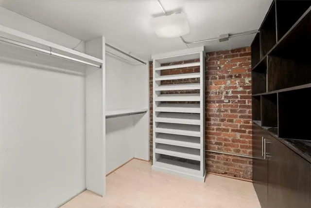 a view of closet area with stairs