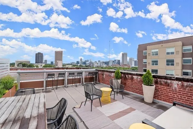 a view of a balcony with two chairs and a table