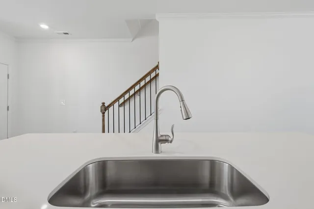 a kitchen with stainless steel appliances a refrigerator sink and cabinets