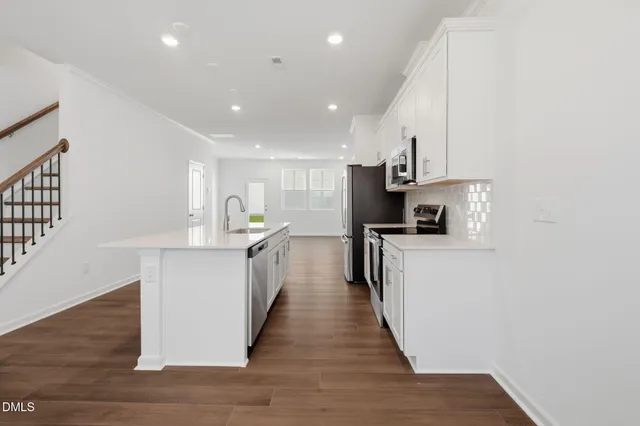 a kitchen with white cabinets and white appliances