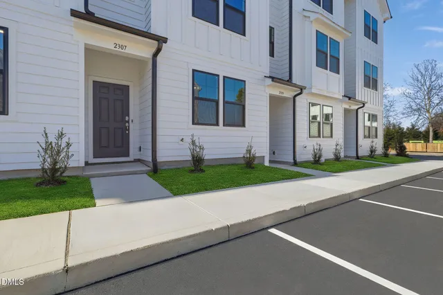 a front view of a house with a yard and a garage