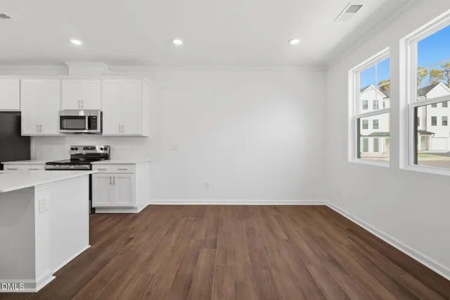 a kitchen with wooden floors and white appliances