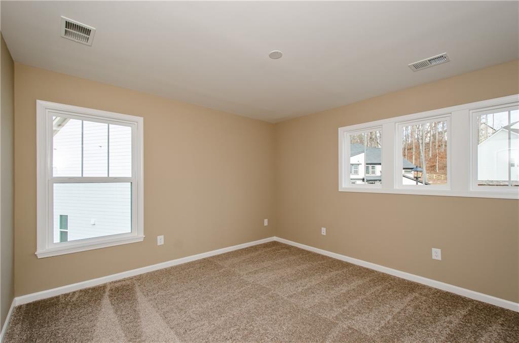 8555 Scenic Ridge Way Ball Ground, GA 30107 - Photo 30 of 74 an empty room with windows
