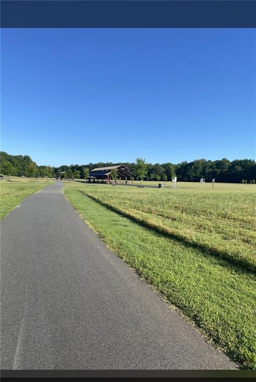 8555 Scenic Ridge Way Ball Ground, GA 30107 - Photo 73 of 74 a view of a lake with houses in the background