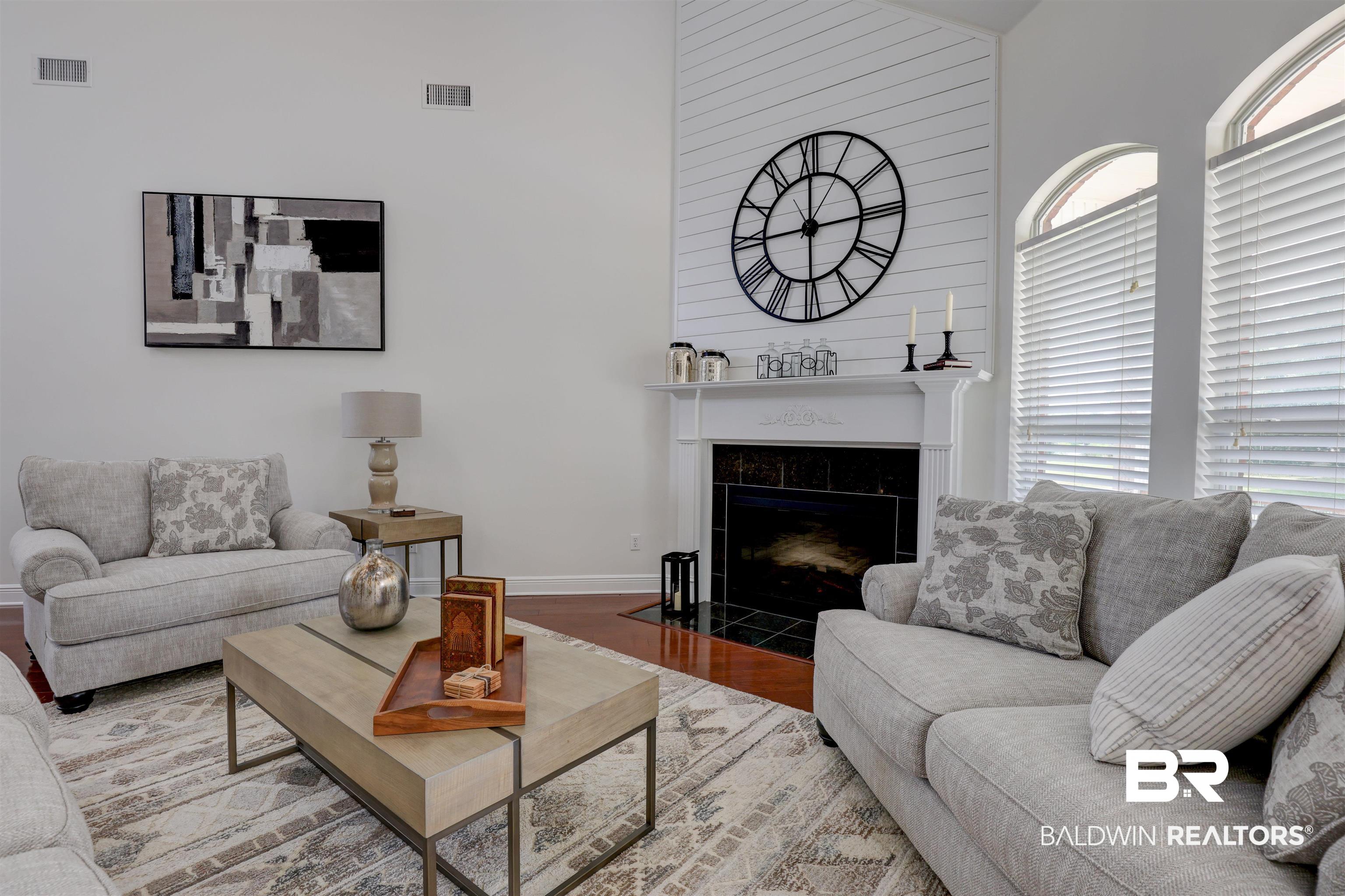 5565 Dawes Lane Theodore, AL 36582 - Photo 8 of 38 Living room with light wood-type flooring, a fireplace, and a high ceiling