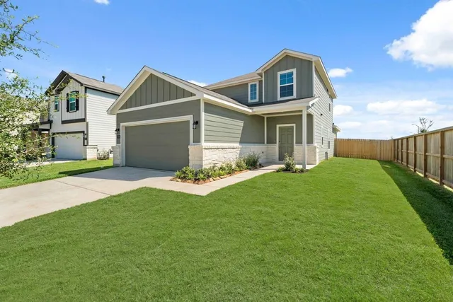 a front view of house with yard and green space