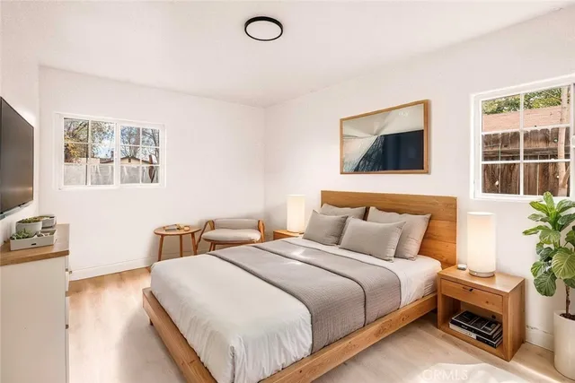 a bedroom with a bed and a flat screen tv