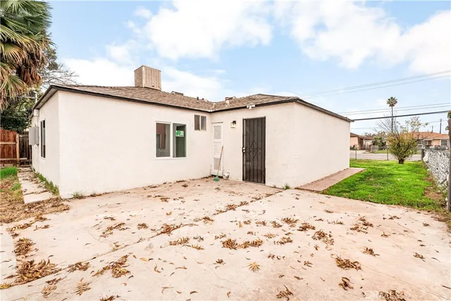 a view of white house with a yard