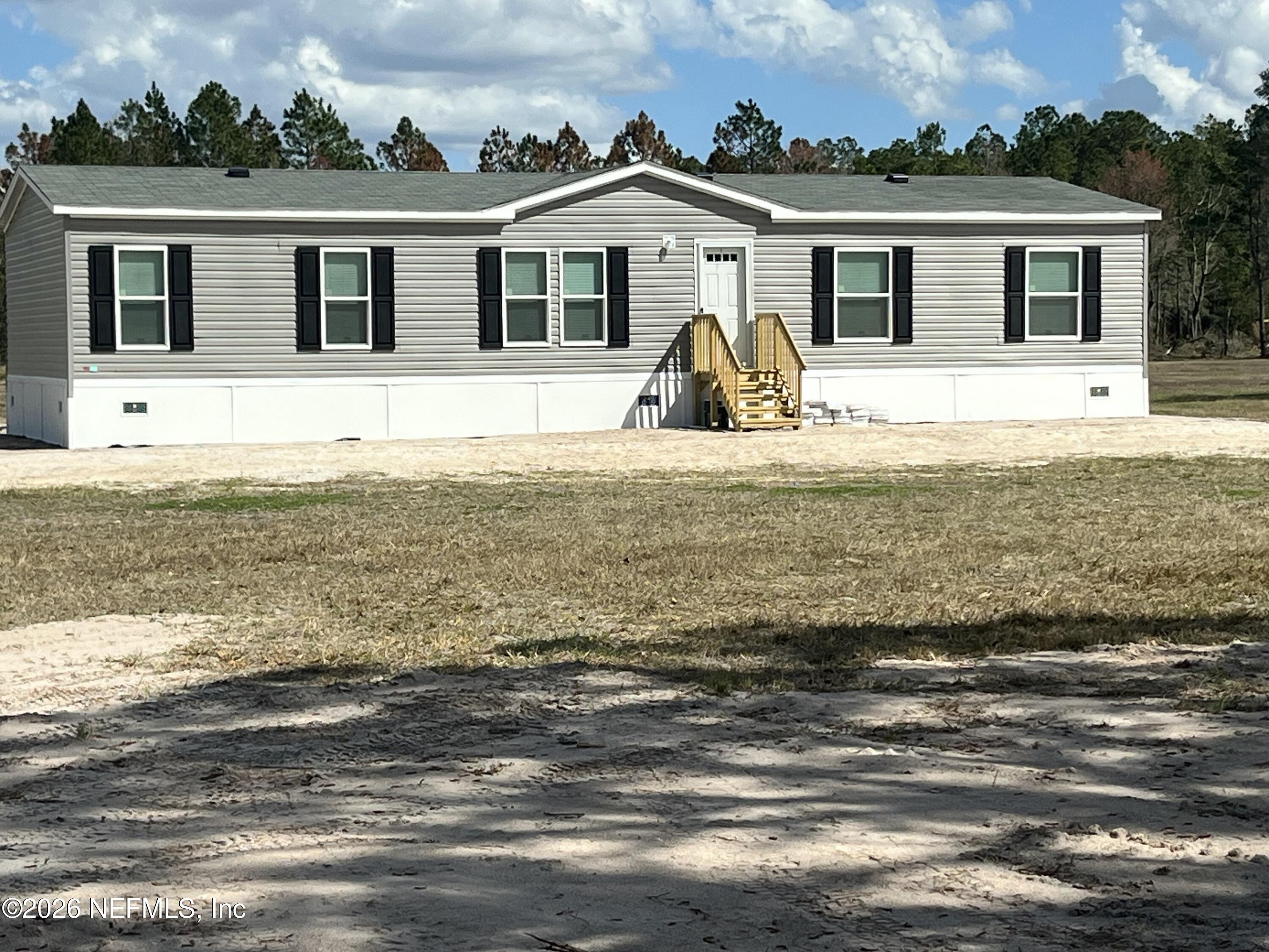 22517 Baxter Grade Road Sanderson, FL 32087 - Photo 25 of 28 a front view of a house with a ocean view