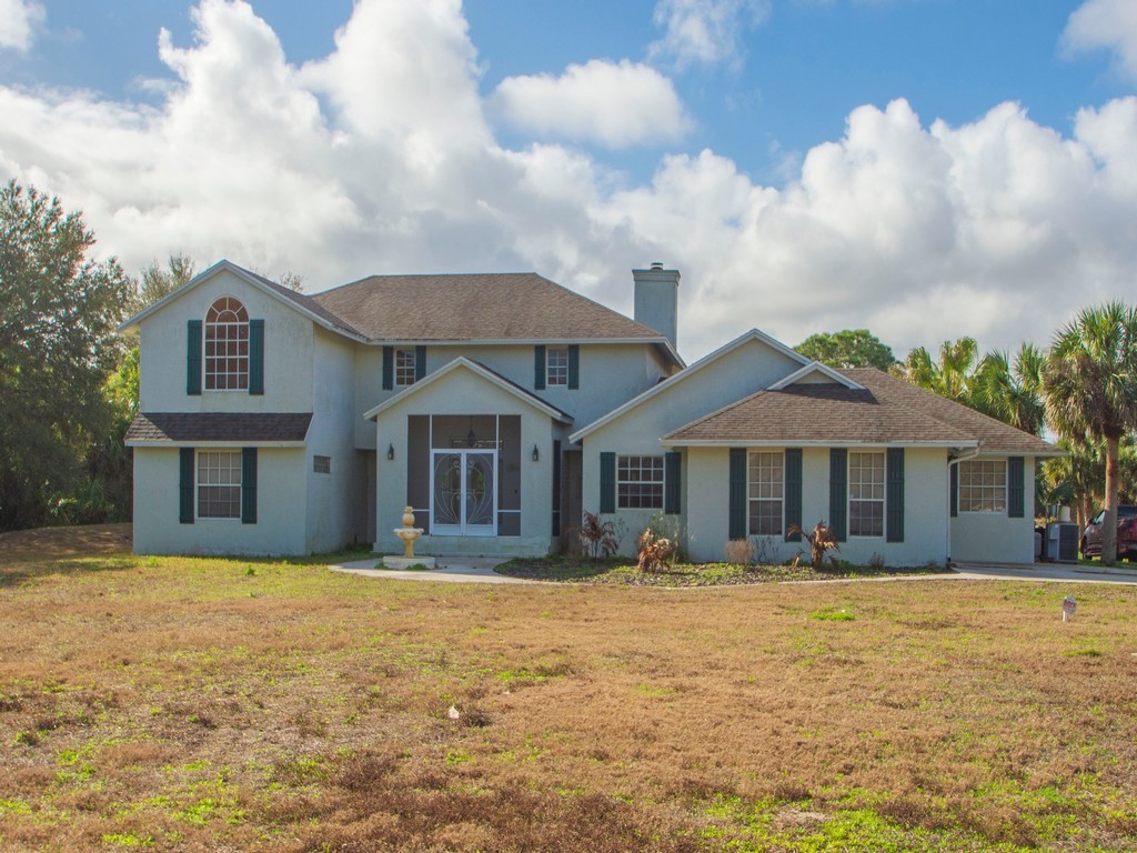 167 Deer Run Road Palm Bay, FL 32909 - Photo 3 of 35 a front view of a house with a yard