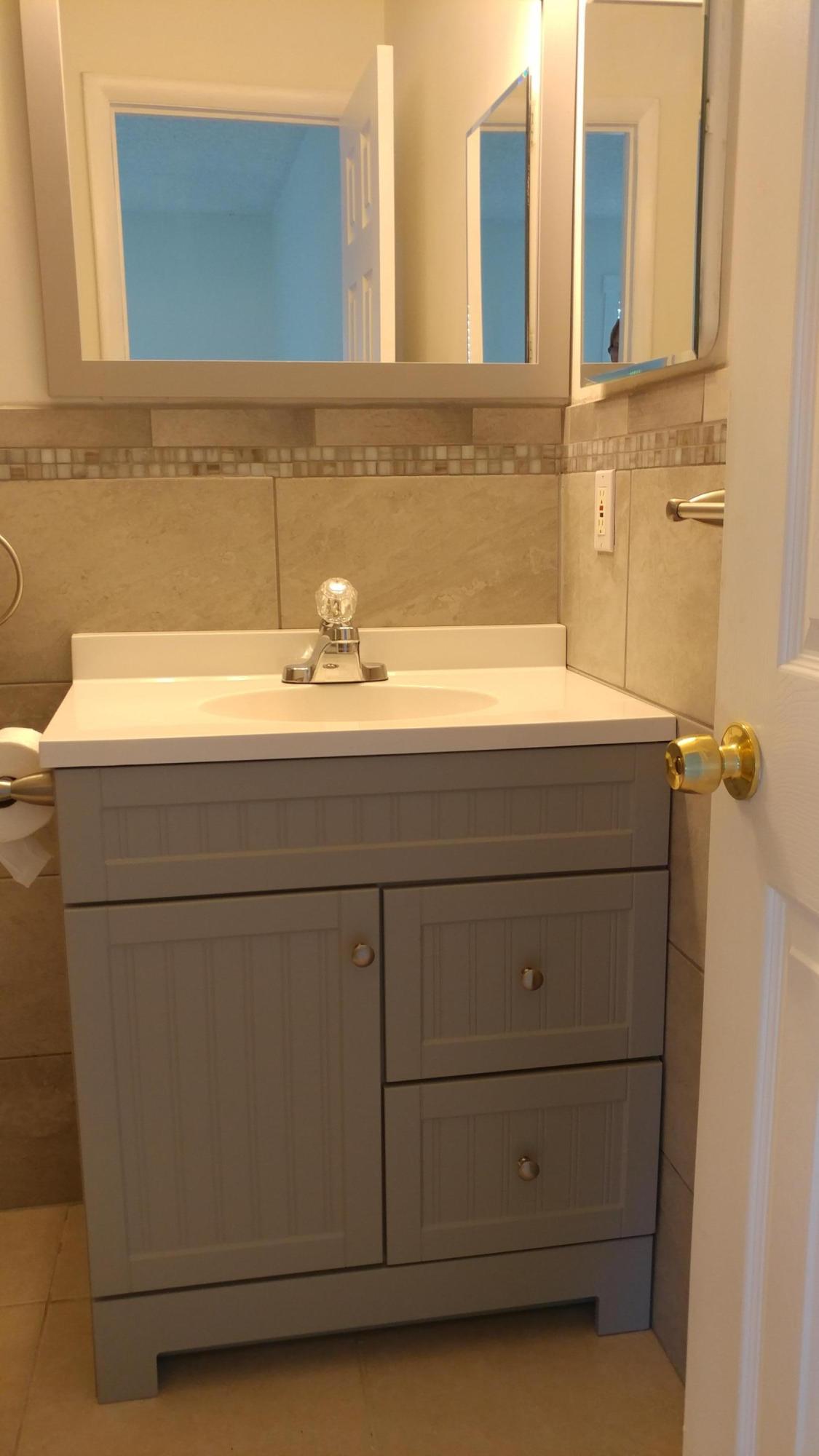650 Northwest Selvitz Road Port St. Lucie, FL 34983 - Photo 17 of 24 a bathroom with a sink and a mirror