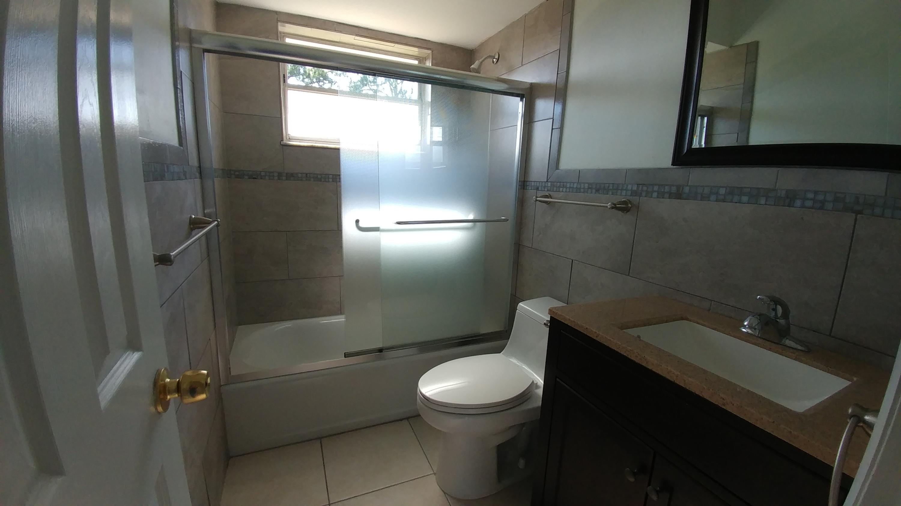 650 Northwest Selvitz Road Port St. Lucie, FL 34983 - Photo 21 of 24 a bathroom with a granite countertop sink toilet and shower