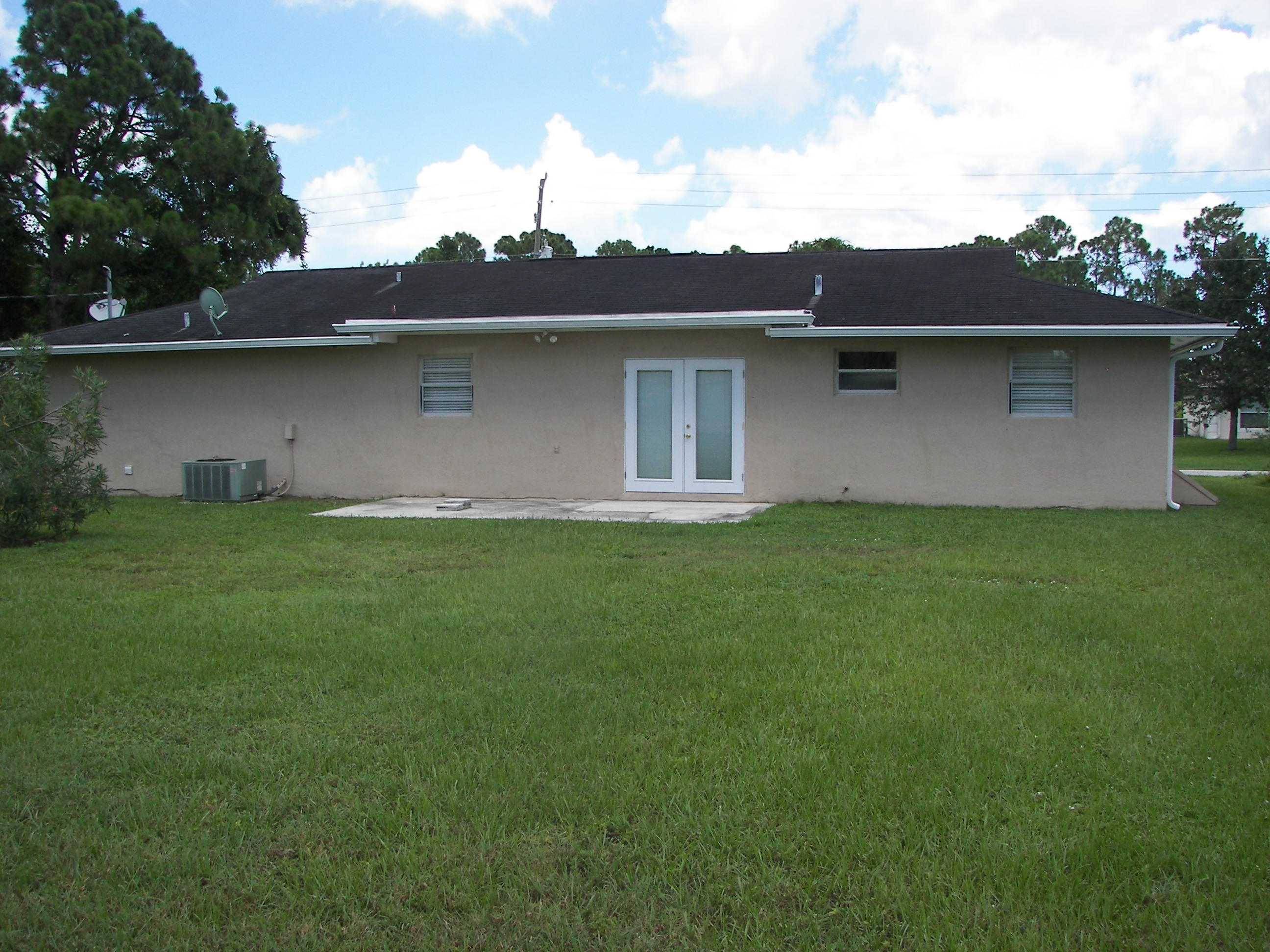 650 Northwest Selvitz Road Port St. Lucie, FL 34983 - Photo 24 of 24 front view of a house with a yard