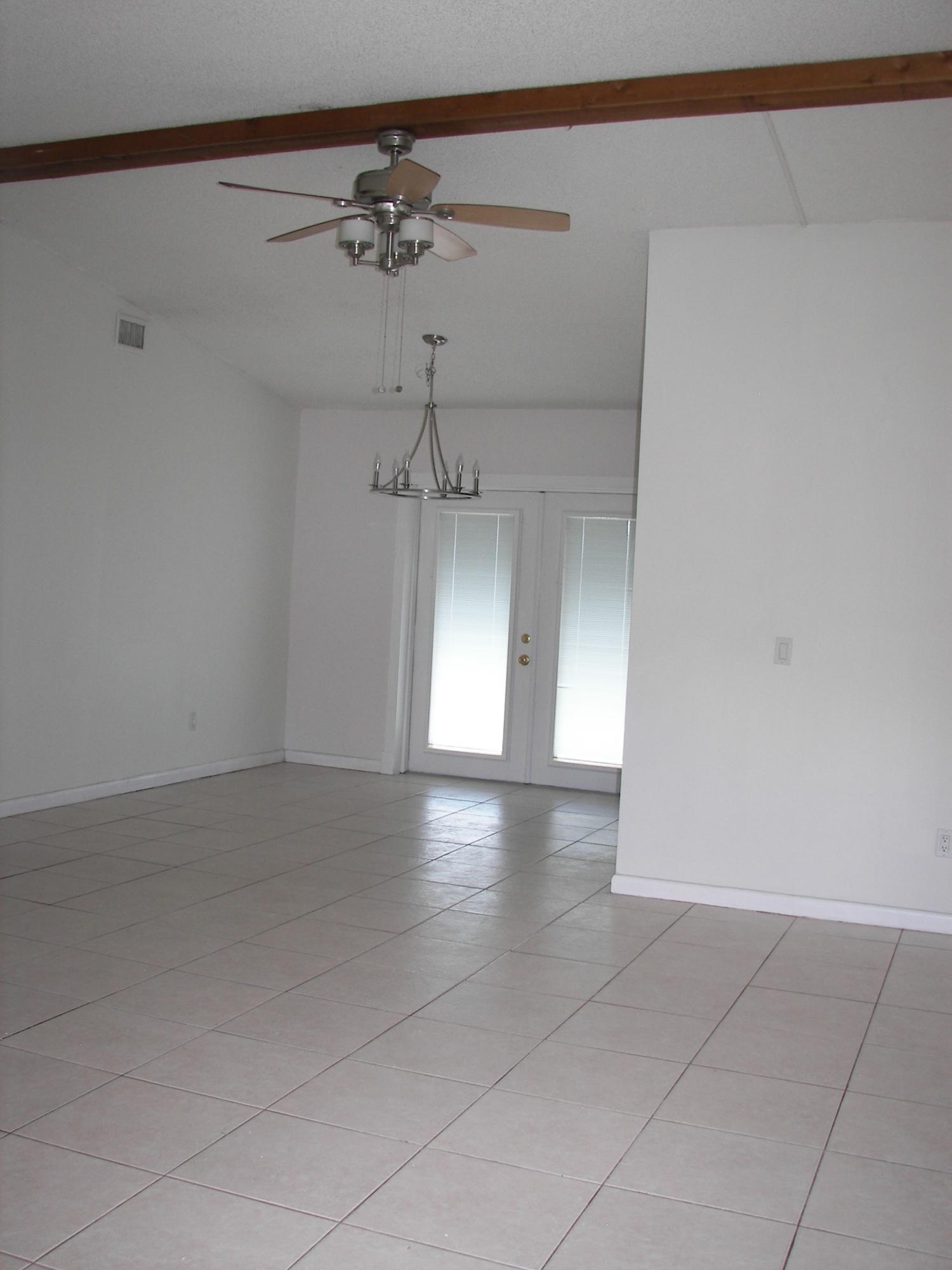 650 Northwest Selvitz Road Port St. Lucie, FL 34983 - Photo 4 of 24 a view of a livingroom with a ceiling fan and window