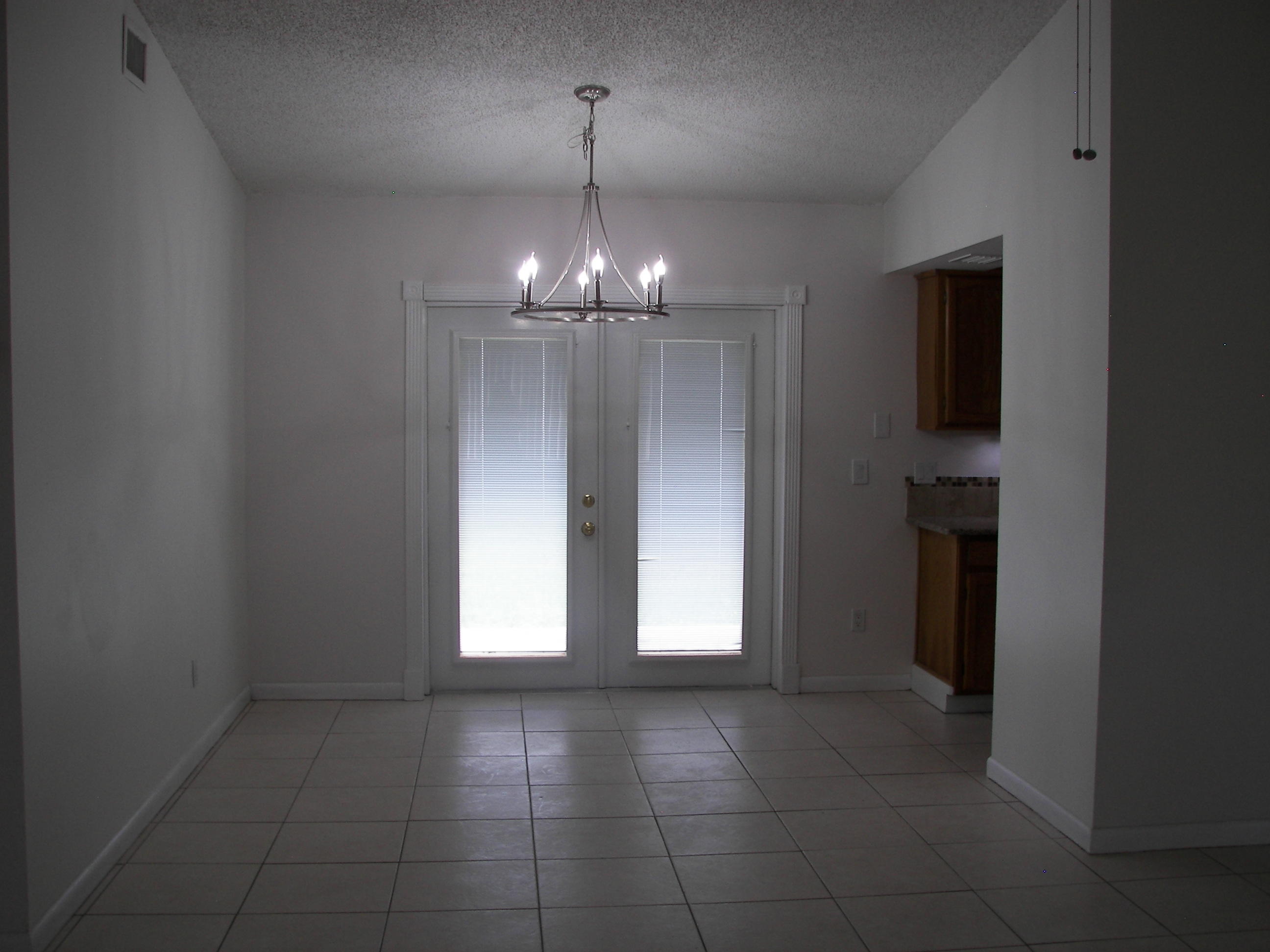 650 Northwest Selvitz Road Port St. Lucie, FL 34983 - Photo 6 of 24 a view of an empty room with closet and chandelier