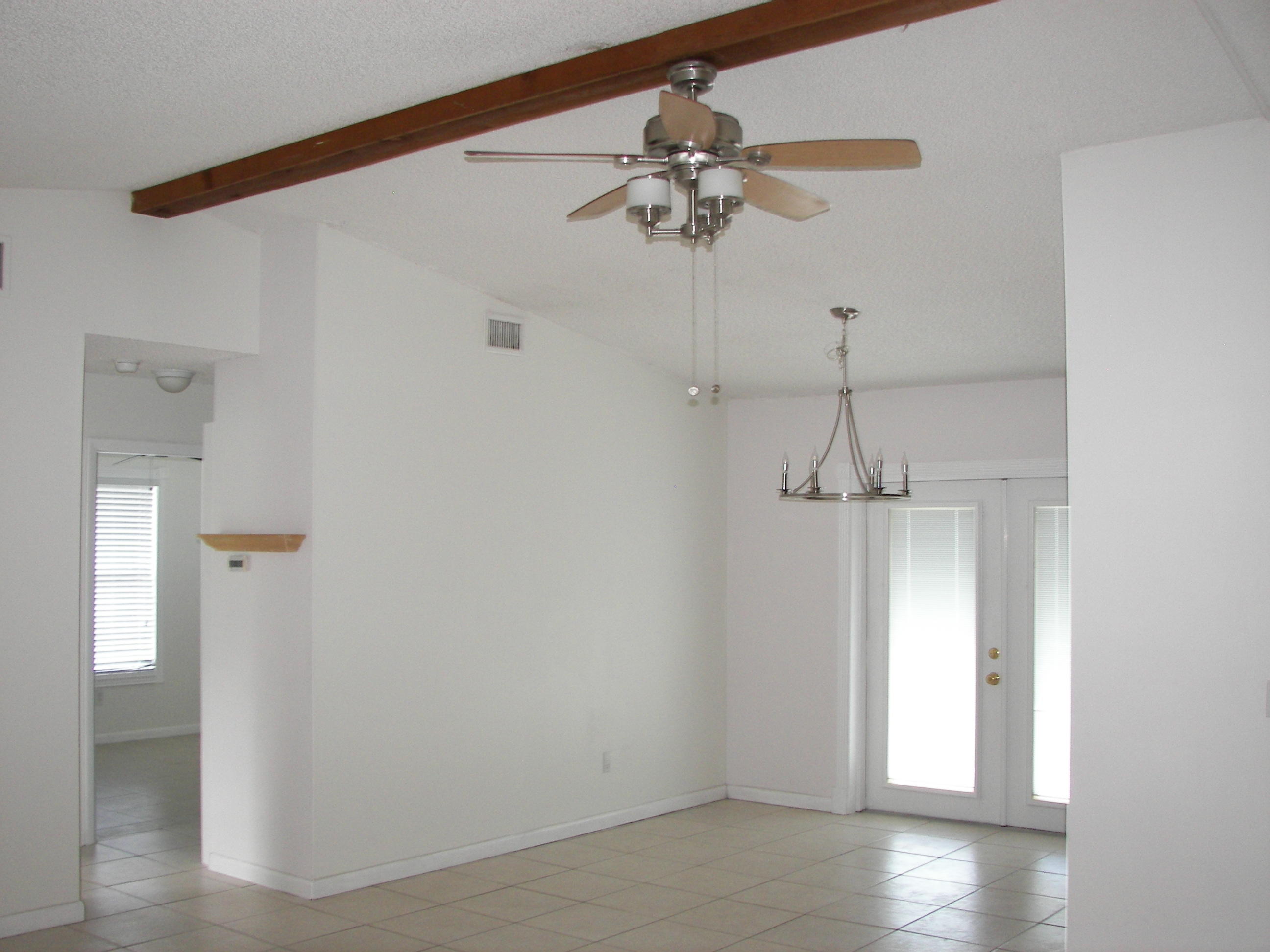 650 Northwest Selvitz Road Port St. Lucie, FL 34983 - Photo 9 of 24 a view of a chandelier fan and wooden floor