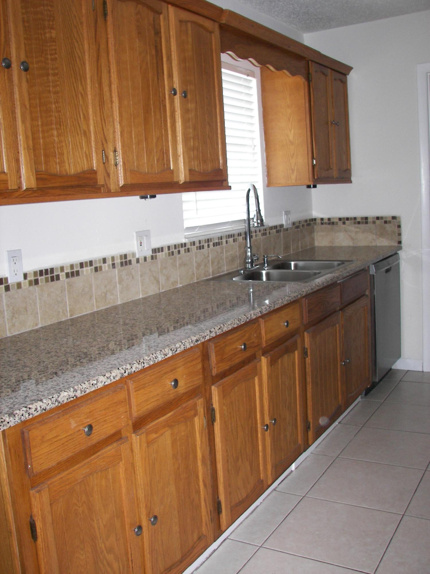 650 Northwest Selvitz Road Port St. Lucie, FL 34983 - Photo 10 of 24 a kitchen with granite countertop cabinets sink and window