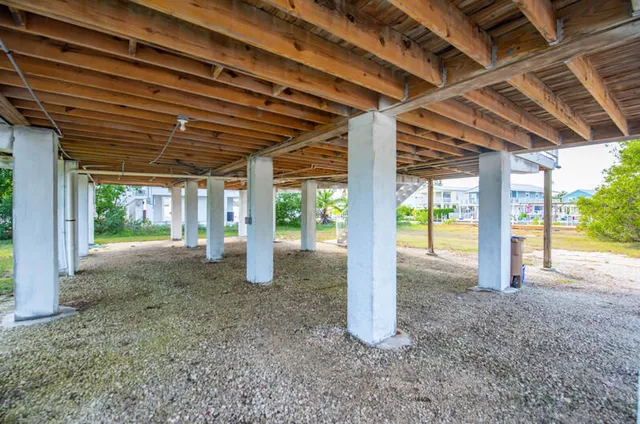 an aerial view of a house with a yard and garden