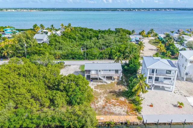 an aerial view of a house with a yard basket ball court and outdoor seating