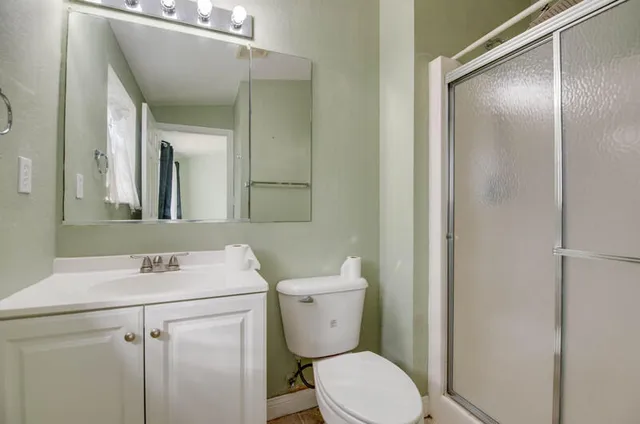 a view of a room with window and carpet