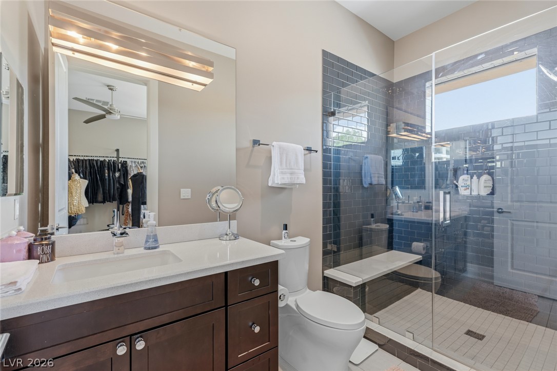 5 Crystal Tree Pass Henderson, NV 89052 - Photo 35 of 67 A well-appointed bathroom offers a glass-enclosed shower and a spacious vanity with an integrated sink.