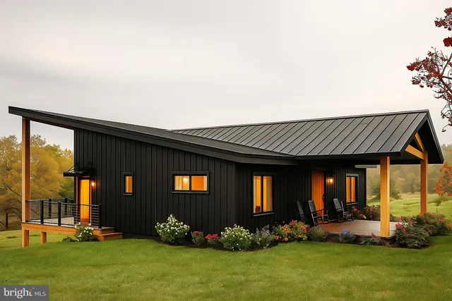 a dining hall with couches a flat screen tv and a floor to ceiling window