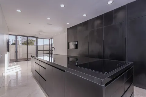 a kitchen with granite countertop a sink and a stove top oven