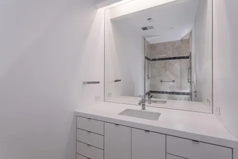 a bathroom with a sink and cabinets