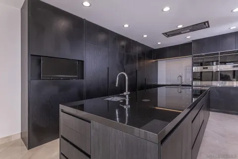 a kitchen with stainless steel appliances granite countertop a sink and a refrigerator
